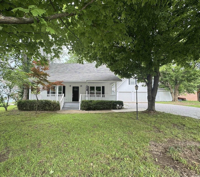 118 Lancaster, Mountain View, AR 72560 - view of front of home with a porch, gravel driveway, a front lawn, board and batten siding, and a garage