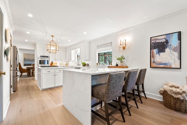 2904 Justin Matthews, North Little Rock, AR 72116 - kitchen featuring appliances with stainless steel finishes, recessed lighting, light wood-style floors, crown molding, and white cabinetry