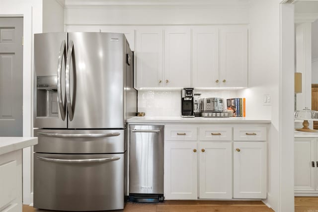2904 Justin Matthews, North Little Rock, AR 72116 - kitchen with stainless steel refrigerator with ice dispenser, white cabinets, light countertops, ornamental molding, and light wood-style floors