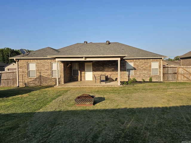 15 Marlin Dr, Austin, AR 72007 - back of house with a patio, an outdoor fire pit, a fenced backyard, brick siding, and roof with shingles