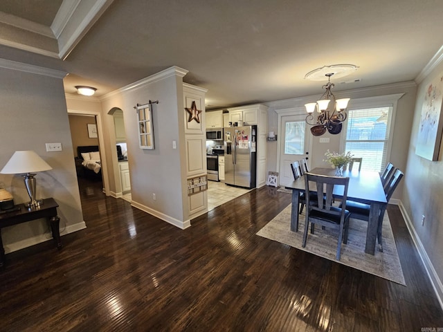 15 Marlin Dr, Austin, AR 72007 - dining area featuring crown molding, wood finished floors, arched walkways, and a chandelier