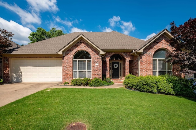 112 Holland Ln, Little Rock, AR 72223 - view of front of house with driveway, brick siding, a front yard, an attached garage, and a shingled roof