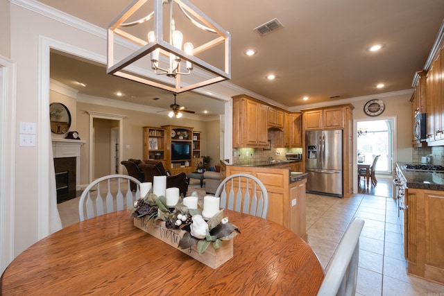 112 Holland Ln, Little Rock, AR 72223 - dining space featuring a glass covered fireplace, ornamental molding, a chandelier, ceiling fan, and recessed lighting