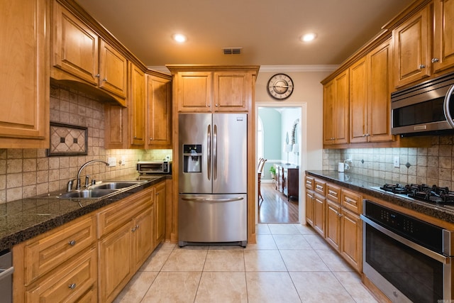 112 Holland Ln, Little Rock, AR 72223 - kitchen featuring appliances with stainless steel finishes, ornamental molding, tasteful backsplash, light tile patterned floors, and brown cabinetry