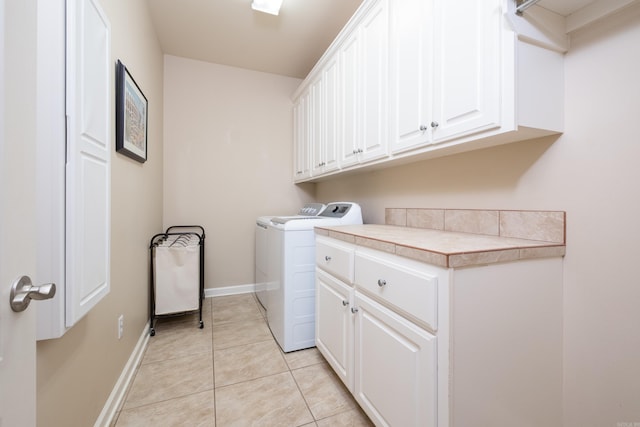 112 Holland Ln, Little Rock, AR 72223 - washroom featuring cabinet space, washing machine and dryer, and light tile patterned floors