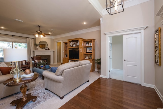 112 Holland Ln, Little Rock, AR 72223 - living area featuring wood finished floors, a fireplace, ceiling fan, crown molding, and recessed lighting