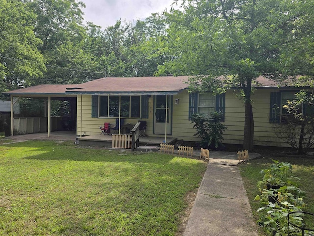 109 S Adams St, Mena, AR 71953 - view of front of house with a front lawn and a carport