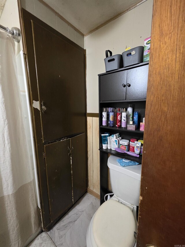 109 S Adams St, Mena, AR 71953 - bathroom with marble look tile flooring and curtained shower