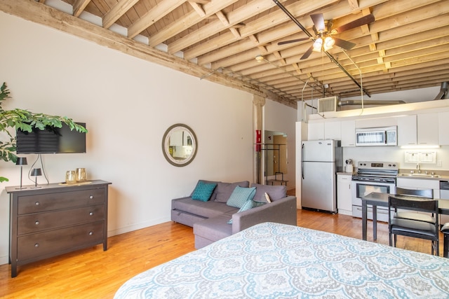 423 E 3rd St Unit 218, Little Rock, AR 72201 - bedroom with freestanding refrigerator and light wood-type flooring