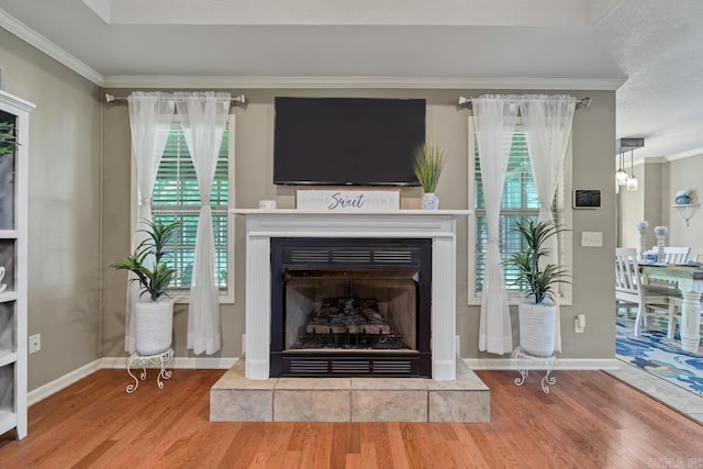 3612 Lexee Dr, Jonesboro, AR 72404 - living area with wood finished floors, crown molding, a fireplace with raised hearth, and a chandelier