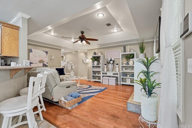 3612 Lexee Dr, Jonesboro, AR 72404 - living area featuring a raised ceiling, wood finished floors, ceiling fan, crown molding, and recessed lighting
