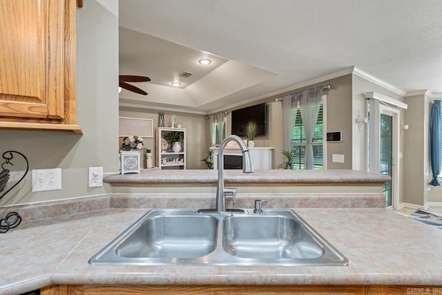 3612 Lexee Dr, Jonesboro, AR 72404 - kitchen featuring a ceiling fan, a raised ceiling, light countertops, and ornamental molding