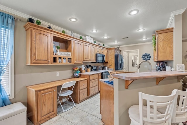 3612 Lexee Dr, Jonesboro, AR 72404 - kitchen with black microwave, range with electric stovetop, built in study area, stainless steel fridge with ice dispenser, and a kitchen breakfast bar