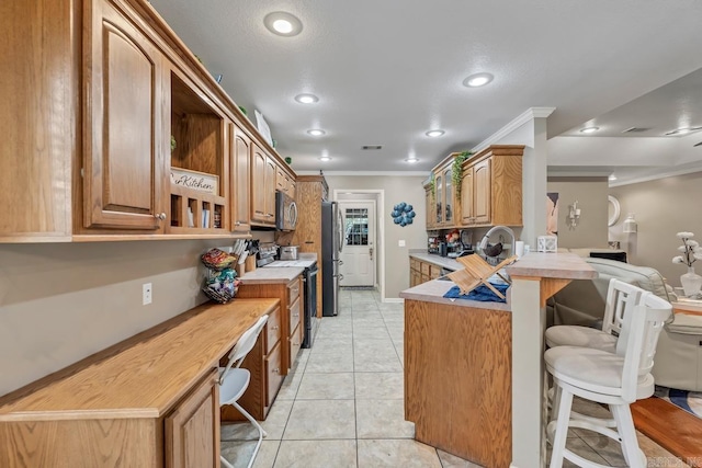 3612 Lexee Dr, Jonesboro, AR 72404 - kitchen featuring appliances with stainless steel finishes, a kitchen breakfast bar, open shelves, ornamental molding, and a peninsula