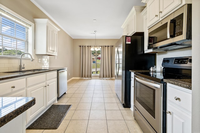 1228 Ridgecrest Dr, Benton, AR 72015 - kitchen featuring stainless steel appliances, tasteful backsplash, white cabinets, ornamental molding, and plenty of natural light