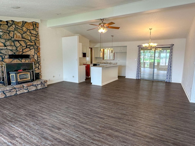 1502 E Emerald Cove Dr, Horseshoe Bend, AR 72512 - unfurnished living room with dark wood finished floors, a chandelier, ceiling fan, and a wood stove