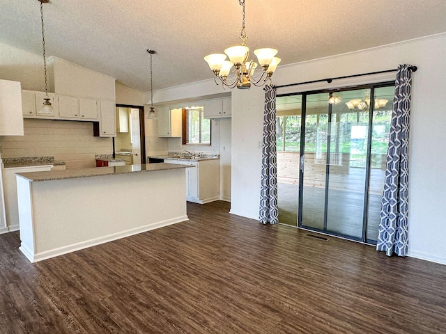 1502 E Emerald Cove Dr, Horseshoe Bend, AR 72512 - kitchen featuring a textured ceiling, dark wood finished floors, a chandelier, white cabinetry, and a kitchen island