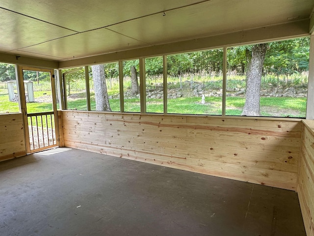 1502 E Emerald Cove Dr, Horseshoe Bend, AR 72512 - unfurnished sunroom featuring concrete flooring and wood walls