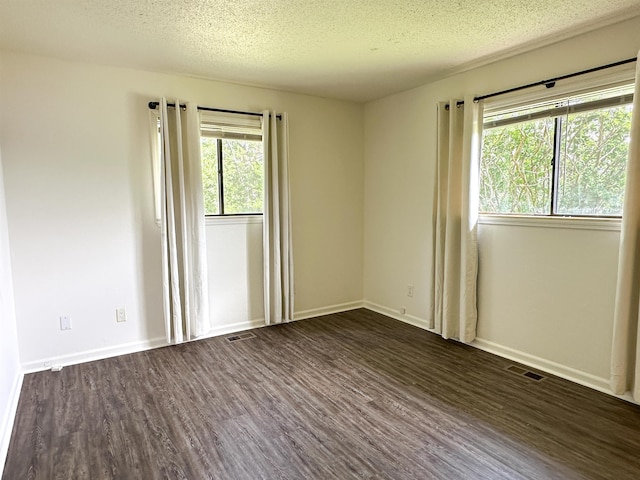 1502 E Emerald Cove Dr, Horseshoe Bend, AR 72512 - unfurnished room featuring dark wood finished floors and a textured ceiling