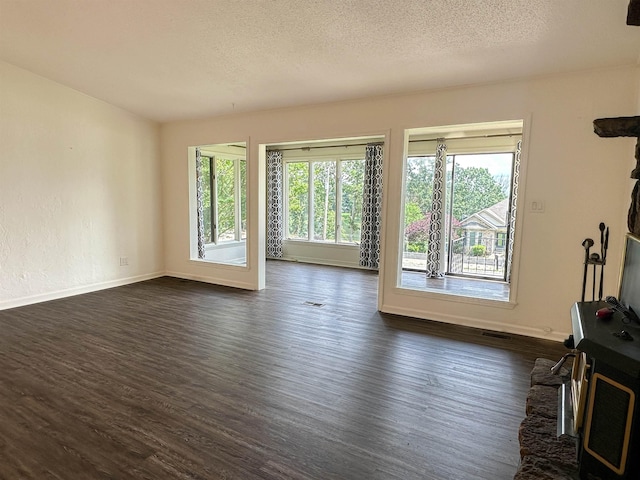 1502 E Emerald Cove Dr, Horseshoe Bend, AR 72512 - unfurnished living room with dark wood finished floors and a textured ceiling