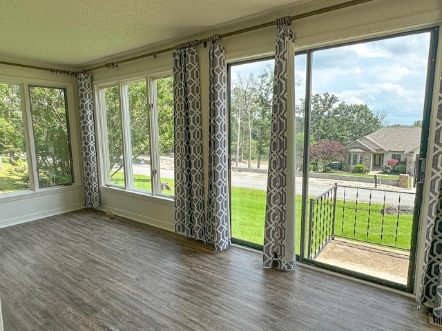1502 E Emerald Cove Dr, Horseshoe Bend, AR 72512 - unfurnished sunroom with wood finished floors, healthy amount of natural light, and a textured ceiling