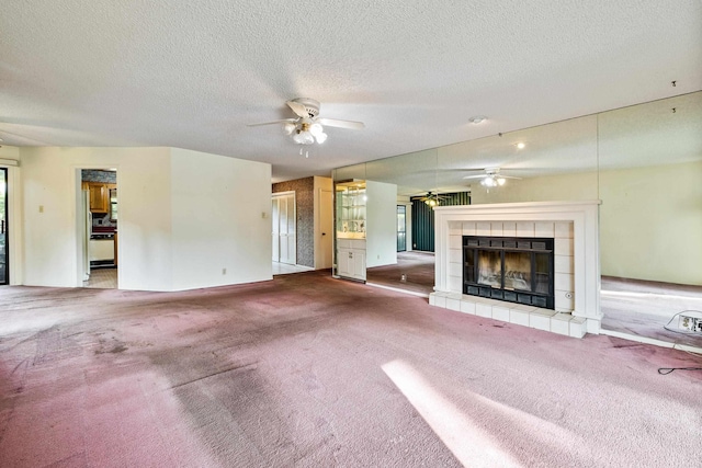2325 Lakeshore Dr Unit C-1, Hot Springs, AR 71913 - unfurnished living room featuring ceiling fan, carpet flooring, a tiled fireplace, and a textured ceiling