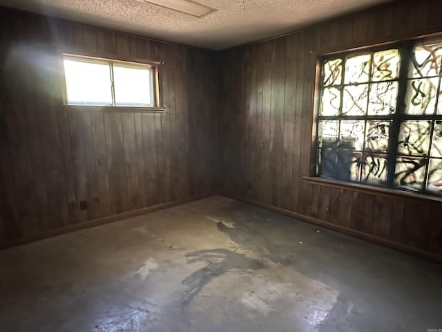 17811 Puckett Rd, Alexander, AR 72002 - empty room featuring a textured ceiling and wooden walls