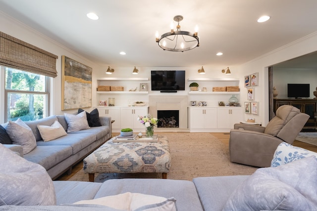 7 Shawbridge Ln, Little Rock, AR 72212 - living room featuring ornamental molding, a chandelier, recessed lighting, light wood-style floors, and built in shelves
