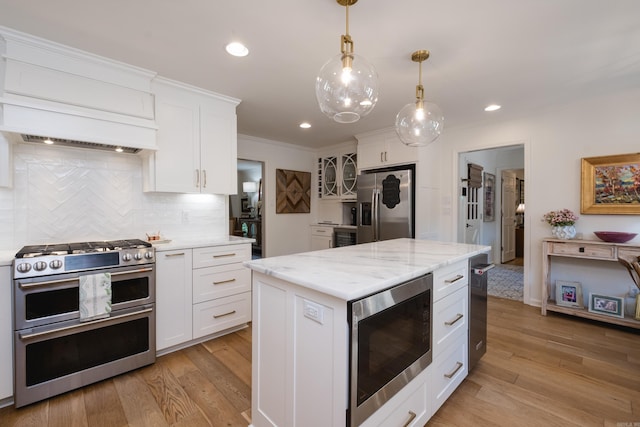 7 Shawbridge Ln, Little Rock, AR 72212 - kitchen with appliances with stainless steel finishes, white cabinets, light wood-type flooring, decorative backsplash, and recessed lighting