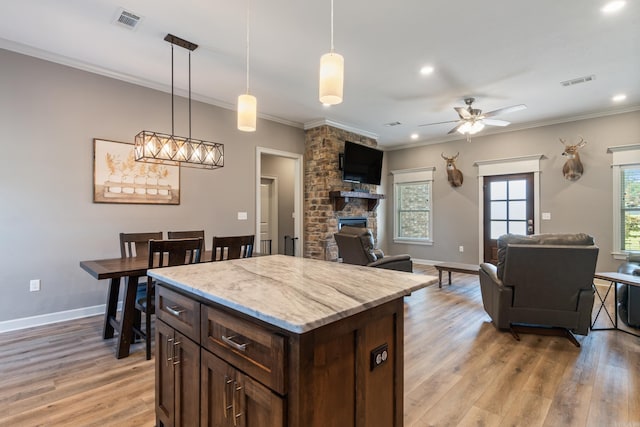 26 Edward Way, Greenbrier, AR 72058 - kitchen with open floor plan, plenty of natural light, crown molding, a ceiling fan, and pendant lighting