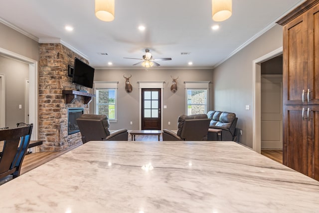 26 Edward Way, Greenbrier, AR 72058 - dining room with wood finished floors, a large fireplace, ceiling fan, ornamental molding, and recessed lighting