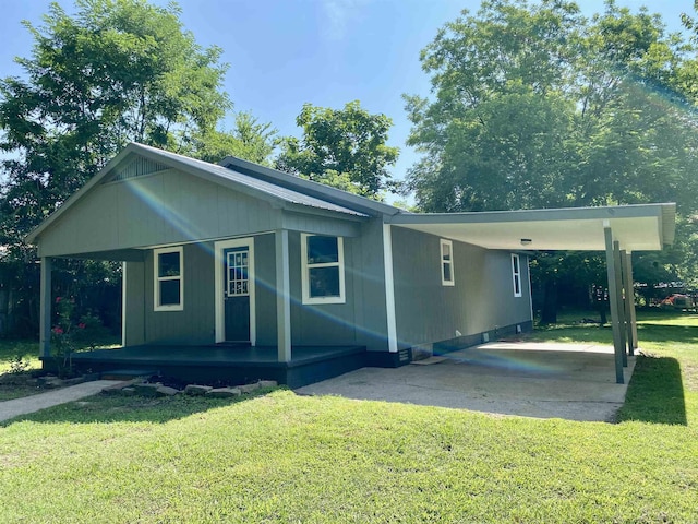 103 S 7th, Coal Hill, AR 72832 - view of front of property featuring a porch, a carport, a front lawn, and driveway
