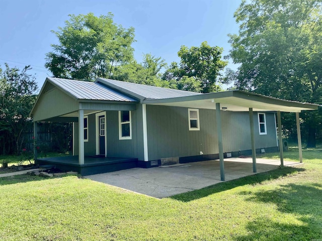 103 S 7th, Coal Hill, AR 72832 - rear view of property featuring an attached carport, a porch, a lawn, and a metal roof