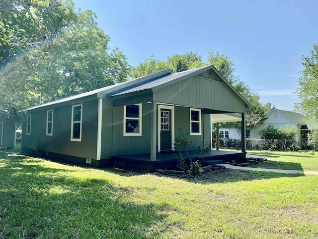 103 S 7th, Coal Hill, AR 72832 - view of front facade with a front yard, an attached carport, and covered porch