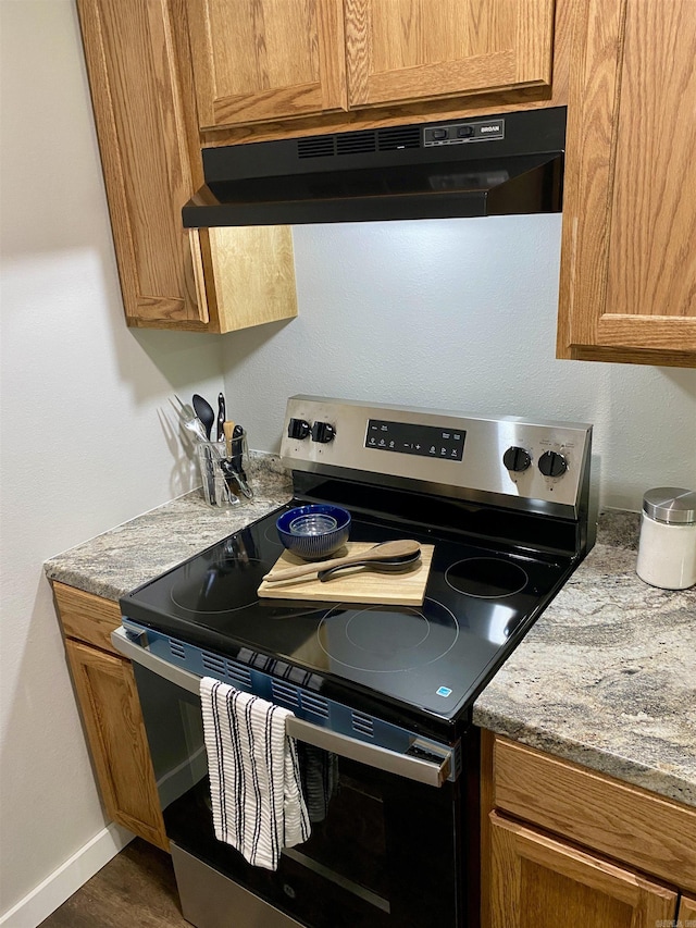 103 S 7th, Coal Hill, AR 72832 - kitchen featuring stainless steel electric stove, ventilation hood, brown cabinets, light stone countertops, and dark wood finished floors