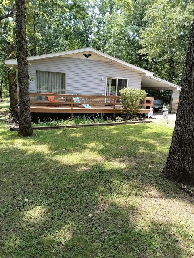 203 Diamond Ln, Horseshoe Bend, AR 72512 - rear view of property with an attached carport, a lawn, and a wooden deck