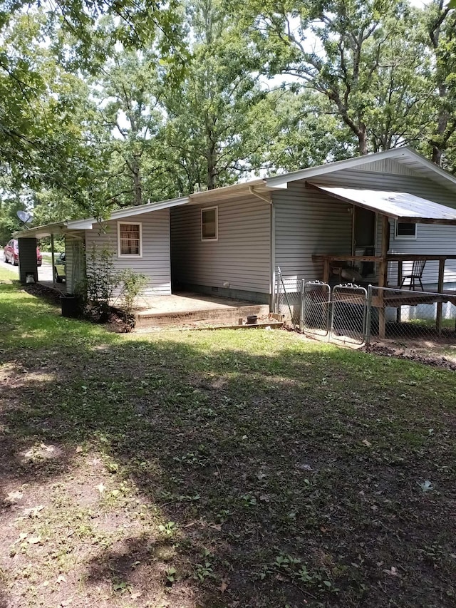 203 Diamond Ln, Horseshoe Bend, AR 72512 - rear view of property featuring a carport and a patio area