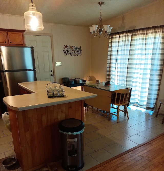 203 Diamond Ln, Horseshoe Bend, AR 72512 - kitchen featuring freestanding refrigerator, a chandelier, light countertops, and hanging light fixtures