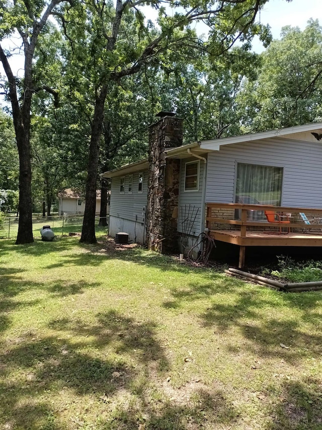 203 Diamond Ln, Horseshoe Bend, AR 72512 - rear view of house featuring a deck, a chimney, and view of scattered trees