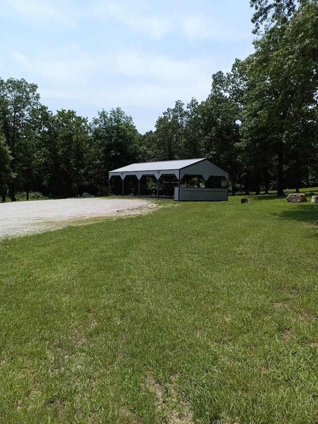 203 Diamond Ln, Horseshoe Bend, AR 72512 - view of grassy yard featuring a detached carport and gravel driveway