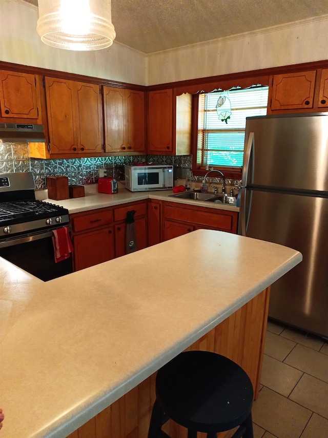 203 Diamond Ln, Horseshoe Bend, AR 72512 - kitchen featuring stainless steel appliances, under cabinet range hood, light countertops, backsplash, and light tile patterned floors