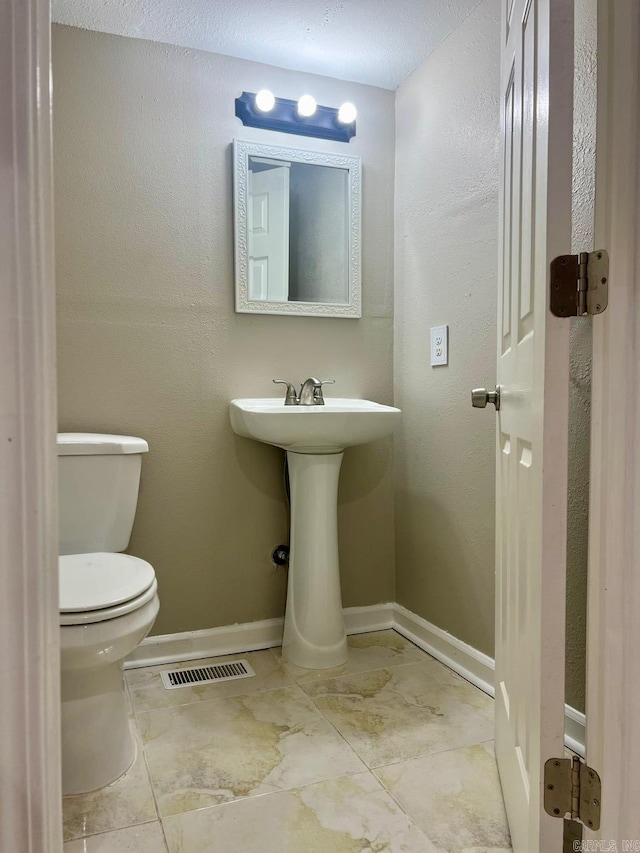 809 Banner St, Benton, AR 72015 - half bathroom with toilet and marble finish floors