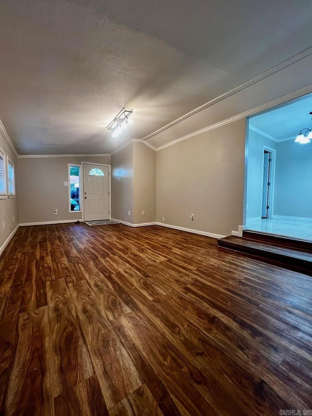 809 Banner St, Benton, AR 72015 - unfurnished living room with dark wood-type flooring, crown molding, a chandelier, vaulted ceiling, and a textured ceiling