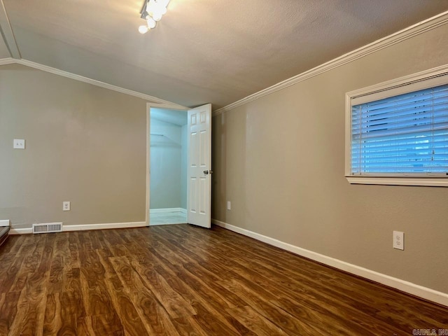 809 Banner St, Benton, AR 72015 - spare room featuring dark wood-style floors, ornamental molding, and vaulted ceiling