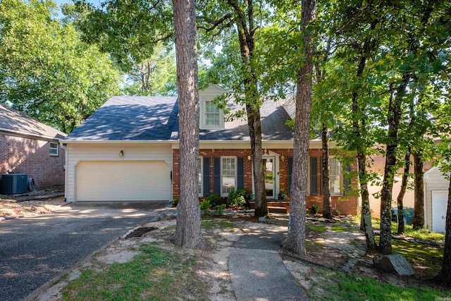 10 Cedar Branch Dr, Little Rock, AR 72223 - view of front of home with driveway, a garage, brick siding, and a shingled roof