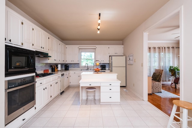 10 Cedar Branch Dr, Little Rock, AR 72223 - kitchen featuring freestanding refrigerator, stainless steel oven, white cabinets, and tasteful backsplash