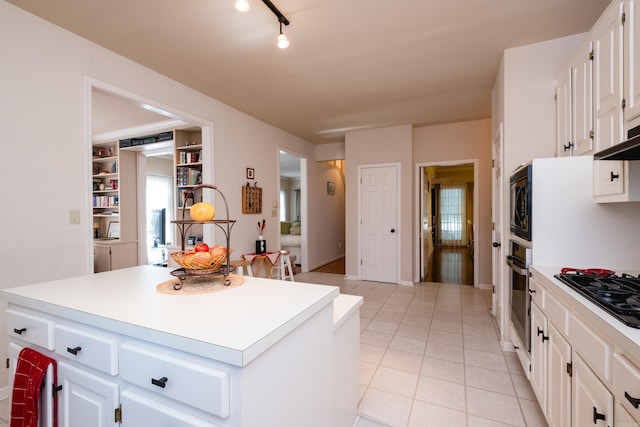 10 Cedar Branch Dr, Little Rock, AR 72223 - kitchen featuring black gas stovetop, oven, white cabinets, a center island, and light countertops