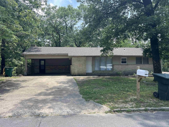 8713 Westwood Ave, Little Rock, AR 72204 - ranch-style house with brick siding, concrete driveway, an attached carport, and a front lawn