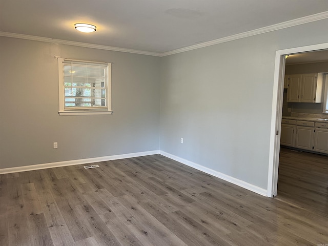 8713 Westwood Ave, Little Rock, AR 72204 - empty room with dark wood-type flooring and crown molding