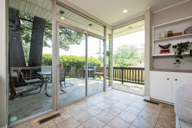 4509 Crestline Dr, North Little Rock, AR 72116 - entryway featuring ornamental molding, healthy amount of natural light, floor to ceiling windows, and stone tile floors